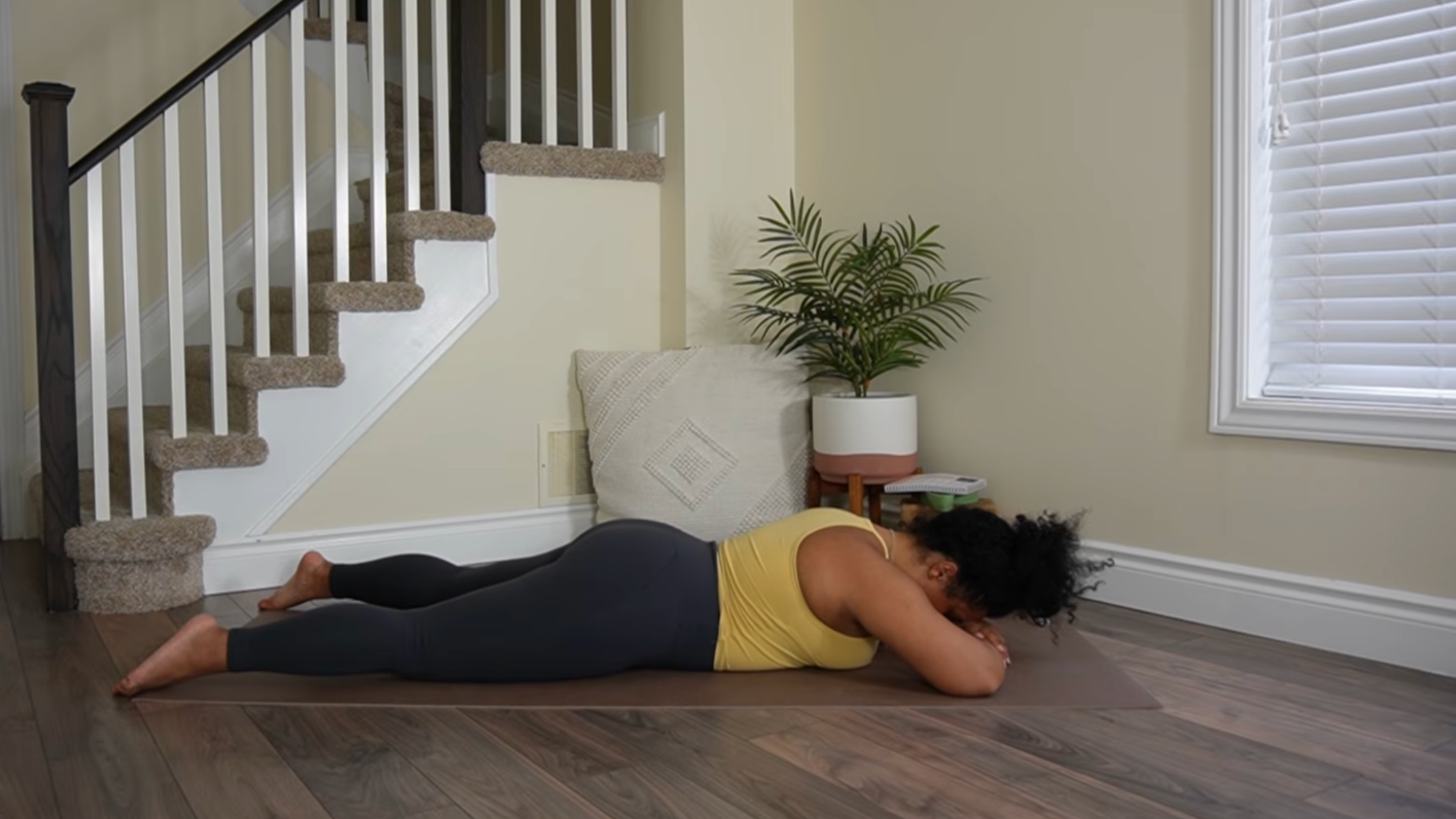 Yoga teacher practicing crocodile pose.